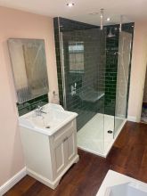 Emerald green brick tiles with traditional basin unit